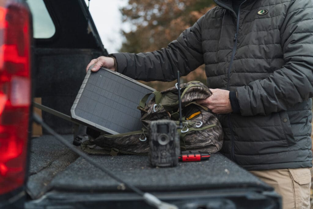Solar battery pack and trail camera on truck bed